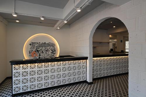 a room with a counter with a mirror and an archway at Bedzzz Xclusiv Morjim, Goa By Leisure Hotels in Morjim