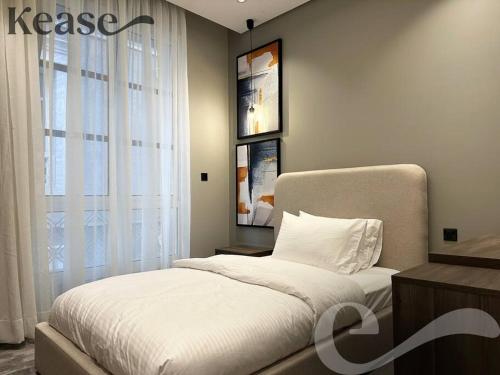 a bedroom with a white bed and a window at Kease Malqa D-12 Royal Touch GZ20 in Riyadh