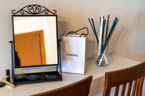 a mirror sitting on top of a table at La Dimora nell'Anfiteatro Superior room and apartment Self check in Elevator Air Conditioning in Lucca