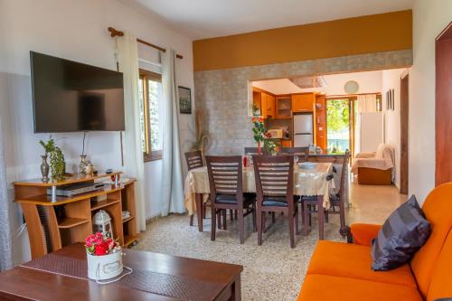 a living room with a table and a dining room at Spiti Damianos Villa Beachfront in Pomos
