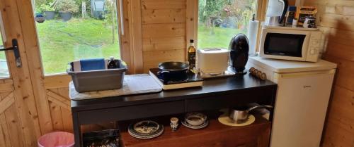 a kitchen in a tiny house with a counter at Lavender Cabin on the Jurassic coast in Swanage