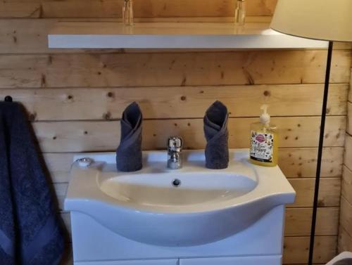a bathroom with a sink with black bunny ears on it at Lavender Cabin on the Jurassic coast in Swanage