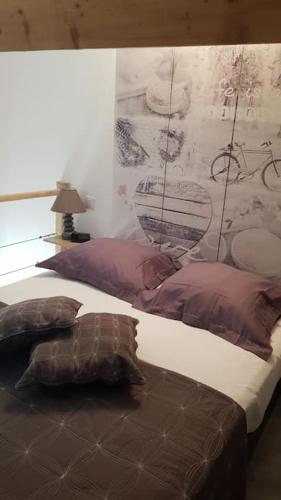 - une chambre avec un lit avec des oreillers et un mur dans l'établissement T1 bis climatimatisé -Agosta Plage- 10 min à pied, à Albitreccia