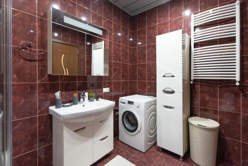 a bathroom with a washing machine and a sink at GG Home - 1-Bedroom apartment in Saburtalo near metro in Tbilisi City