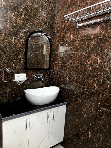 a bathroom with a white sink and a mirror at Hotel Trending Stay in New Delhi