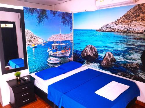 a bedroom with a blue bed and a boat in the water at Apartamento Encanto in Puerto Triunfo