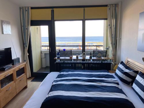 a bedroom with a bed with a view of the ocean at Ferienwohnung Schlosser in Kiel