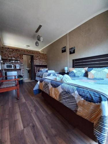 a large bedroom with two beds in it at Courageous Self Catering Accommodation in Harrismith