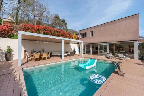 a swimming pool in the backyard of a house at Villa Dolce Vita With Private Pool - Happy Rentals in Lugano