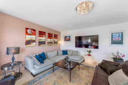 a living room with a couch and a table at Villa Dolce Vita With Private Pool in Lugano