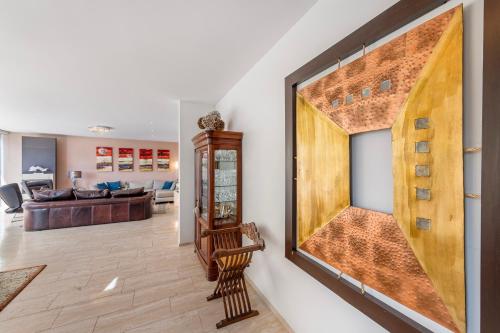 a living room with a large painting on the wall at Villa Dolce Vita With Private Pool in Lugano