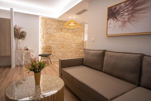 a living room with a couch and a table at Olvio Suites in Kardamili