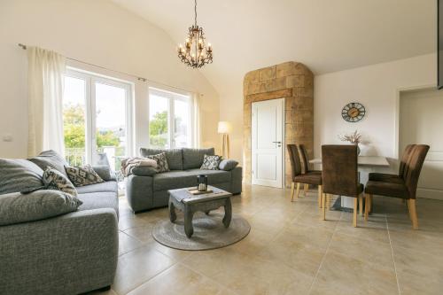 a living room with a couch and a table at MEMORY - Ferienapartments & Zimmer - Mediterraner Flair in der Rhön in Bischofsheim an der Rhön