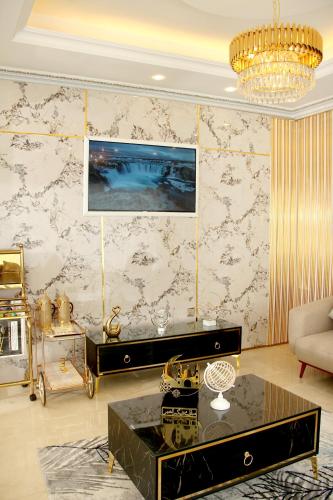 a living room with a couch and a table at Al BARAKAH HOTEL in Sharjah