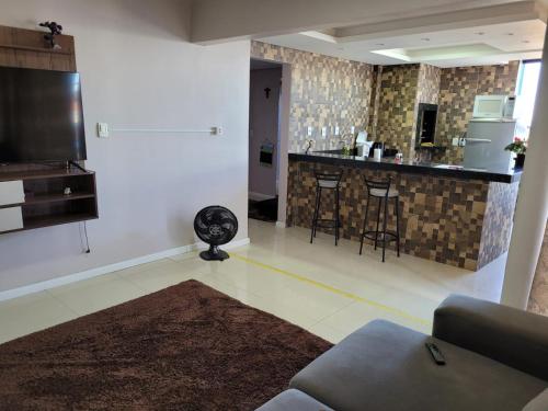 a living room with a kitchen and a bar at Pousada Aparecida in Ametista do Sul