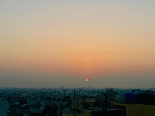 a view of a city with the sun setting at Madri Haveli in Udaipur