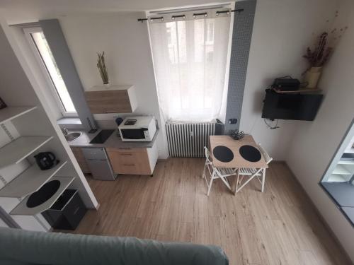 an aerial view of a living room with a couch and a table at Studio proche centre in Pontarlier