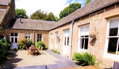 an outside view of a house with a courtyard at Westwood Cottage in Dundee