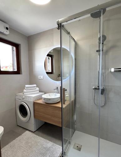 a bathroom with a washing machine and a washer at Apartments Flora 1 in Rab