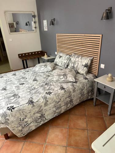 a bedroom with a bed and a wooden headboard at Chez Camille in Épernay