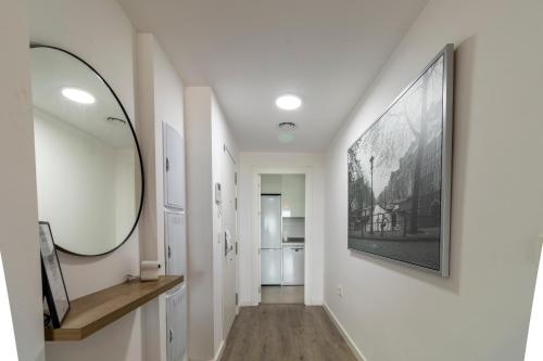 a hallway with a large mirror on a wall at RentitSpain - Playa Granada - Apartamento Aguacate Golf y Costa in Motril