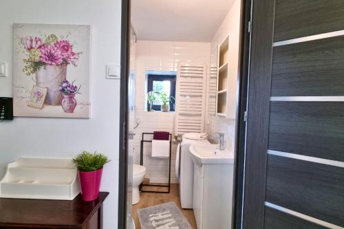 uma casa de banho com um WC branco e um lavatório. em Apartament Nawojowski em Nowy Sącz