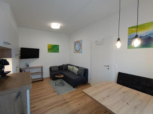 a living room with a couch and a table at Ferienwohnung Gerlitzenblick in Villach