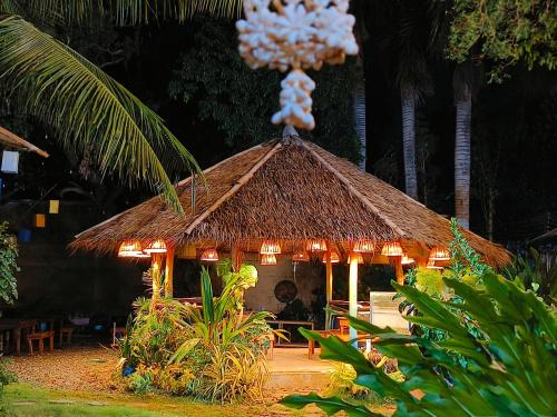 a hut with lights on top of it at Lokal Hut Bed and Breakfast in Puerto Princesa City