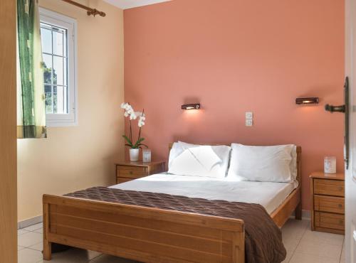 a bedroom with a bed with white sheets and a window at Socrates studio in Laganas
