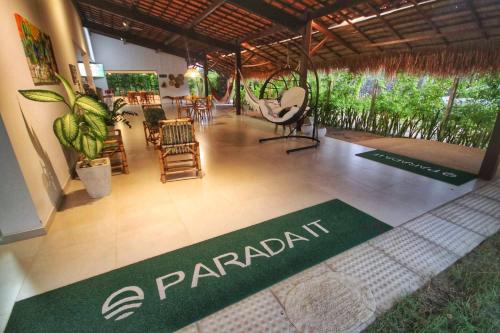 a restaurant with chairs and a sign that says pararia at Parada IT in Japaratinga