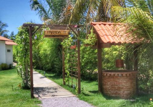 a sign for a garden in front of a house at Parada IT in Japaratinga