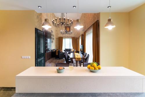 a kitchen with a white counter with fruit on it at Serenity Villas in Kolimbia