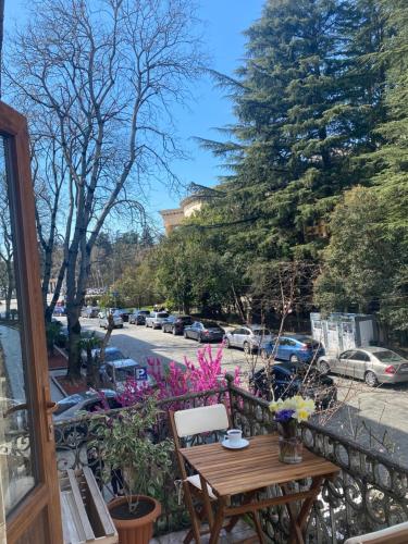 a wooden table and chairs on a balcony at Moedani-Very Center Apartments in Kutaisi in Kutaisi