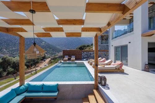 a swimming pool with a view of a house at Sunny Drops Villas by Estia in Balíon
