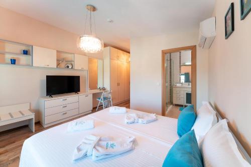 a bedroom with a bed with towels on it at Serenity Villas in Kolimbia