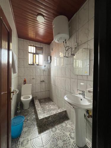 a bathroom with a sink and a toilet at NINHO APPARTEMENT in Rubavu
