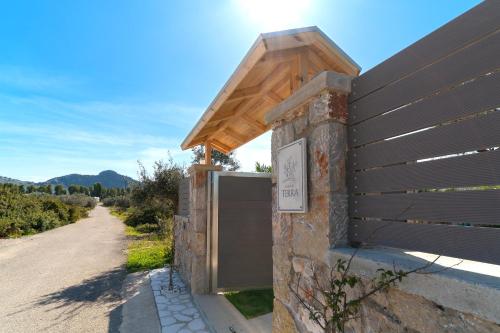 a building with a gate and a wooden fence at Serenity Villas in Kolimbia