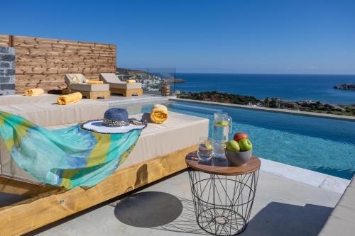 a resort with a pool and a table with fruit on it at Sunny Drops Villas by Estia in Balíon