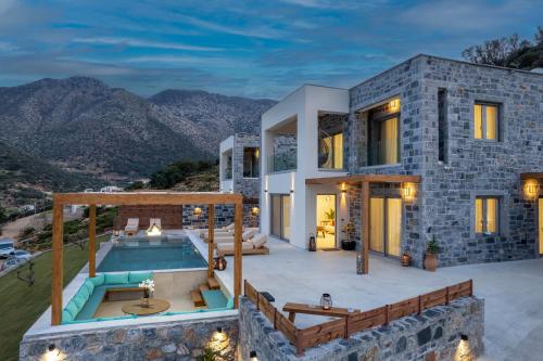 a villa with a swimming pool and a house at Sunny Drops Villas by Estia in Balíon