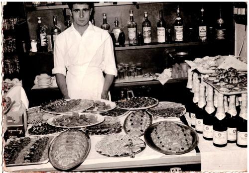 a man standing in front of a buffet of food at Albergo Santo Spirito in Molini di Triora