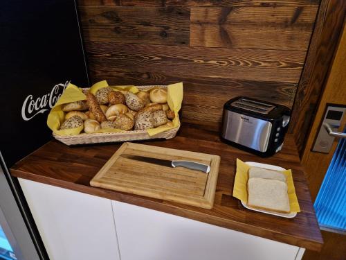 a counter with a tray of bread and a box of food at Pension Sonnenheim in Gmünd in Kärnten