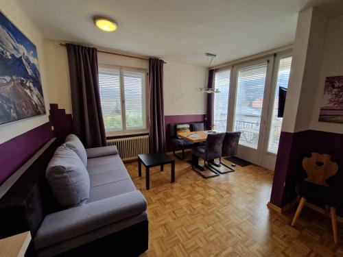 a living room with a couch and a table at Pension Sonnenheim Rooms&Apartments in Gmünd in Kärnten