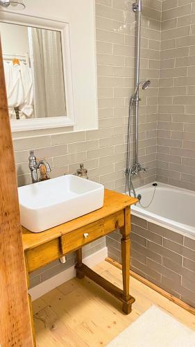 a bathroom with a white sink and a tub at Sebuzínka in Ústí nad Labem