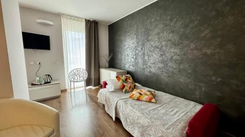 a living room with a couch and a wall at Hotel Royal in Riva del Garda