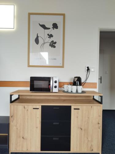 a wooden counter with a microwave on top of it at Morava 307 Uherské Hradiště Šafaříkova 855 in Uherské Hradiště