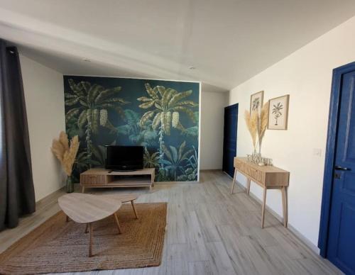 a living room with a large painting on the wall at centre de Thuir appart cosy in Thuir