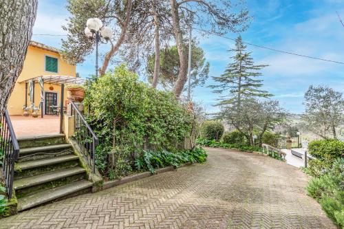 a house with a staircase leading to a driveway at Villa Paola Private Pool Gym in Chianti - Happy Rentals in Montespertoli
