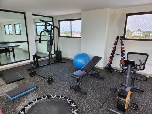 a gym with exercise equipment in a room at Apartamento - Centro Porto de Galinhas in Escada