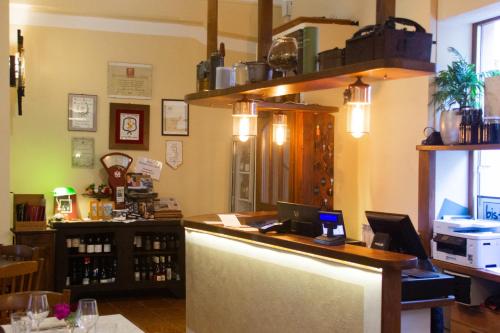 a bar in a wine shop with a counter at Albergo Santo Spirito in Molini di Triora