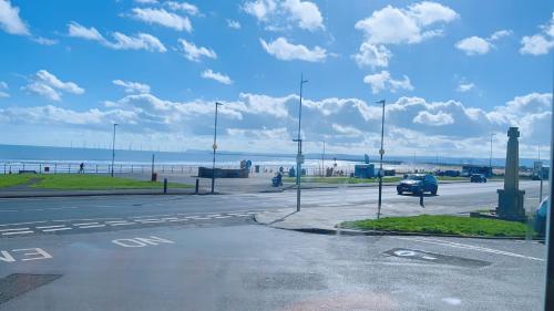 an empty parking lot next to the beach with a car at The Norton in Seaton Carew